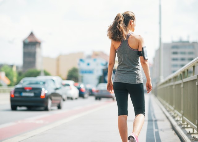 woman walking for exercise in a city