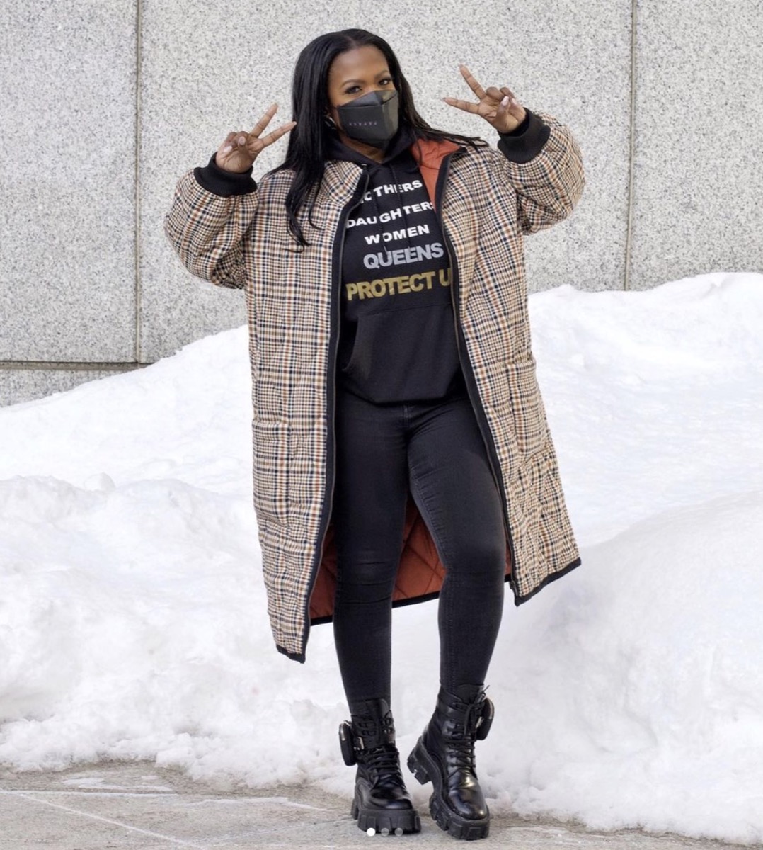 kandi burruss in burberry coat, black leggings, black sweatshirt, and black mask flashing peace