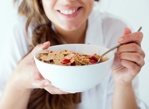 Woman eating a bowl of cereal