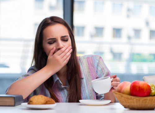 Sleepy woman eating