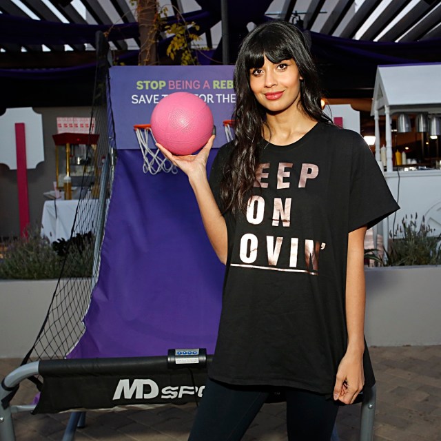 jameela jamil in black t-shirt holding pink basketball