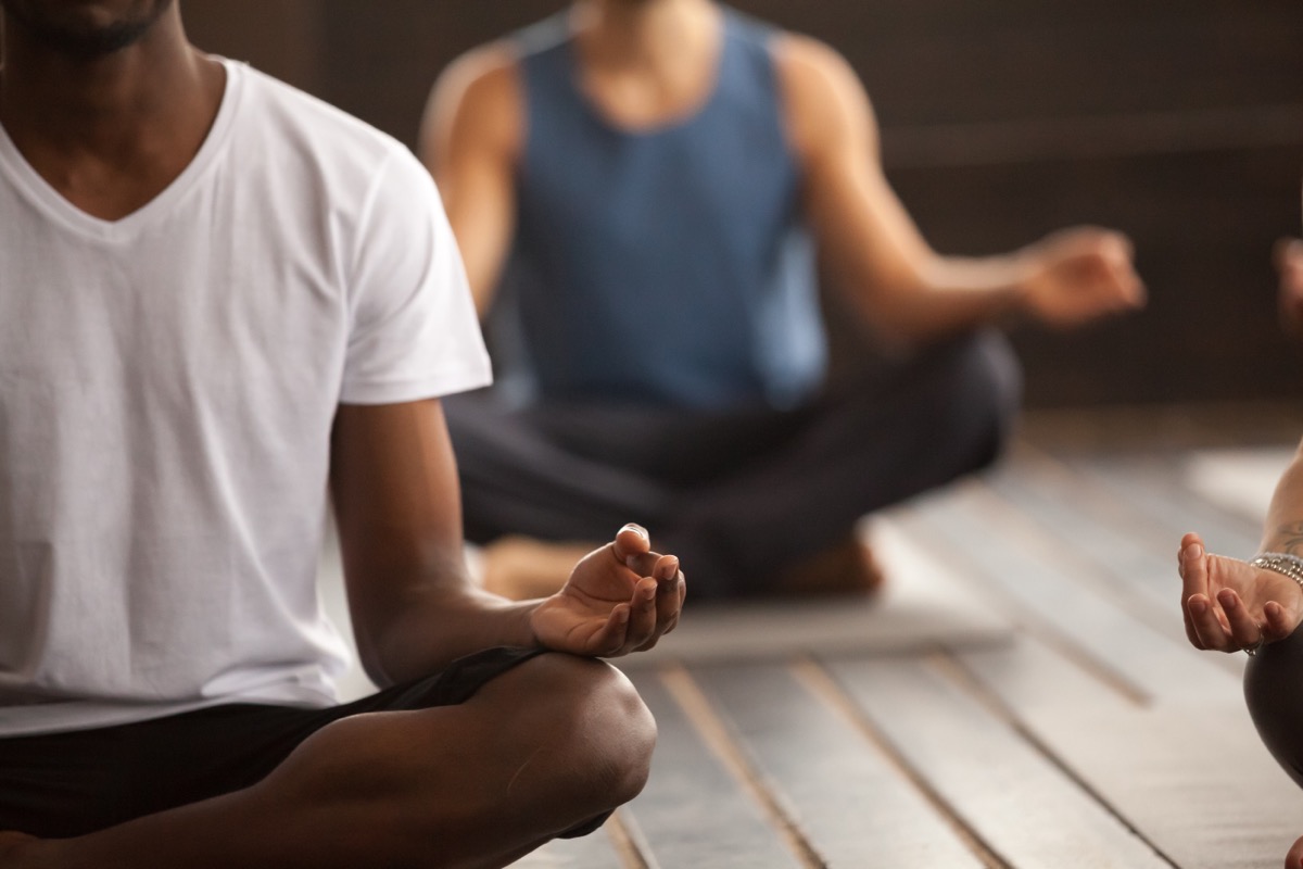 three people in meditation class