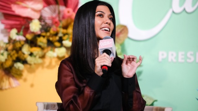 kourtney kardashian doing interview holding pink mic