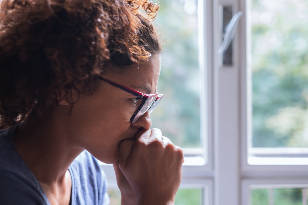 sad woman near window thinking