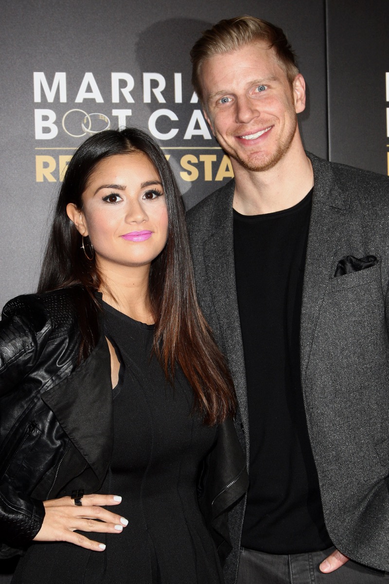 catherine giudici and sean lowe smiling on red carpet