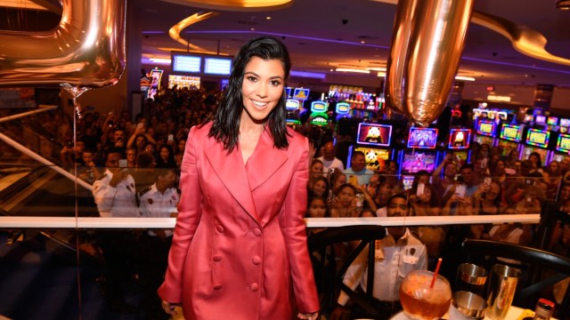 kourtney kardashian in red suit at restaurant