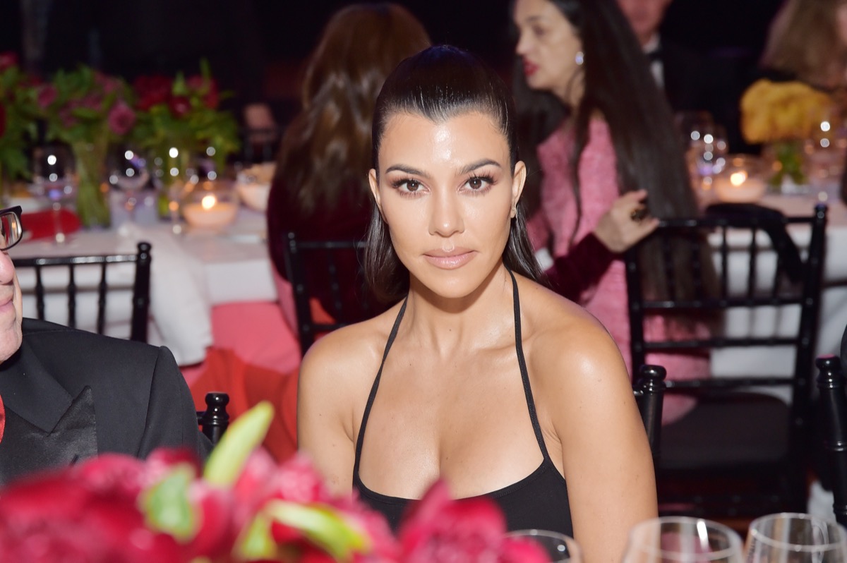 kourtney kardashian seated in black dress