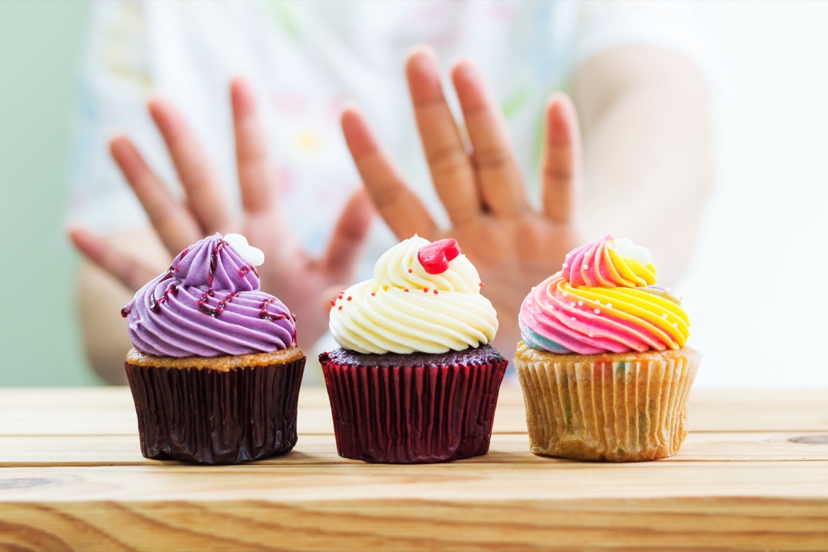 woman refusing cupcakes