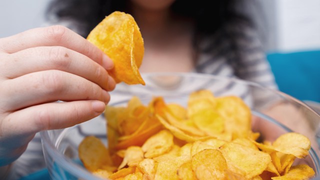 woman eating potato chips