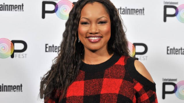 garcelle beauvais in red and black buffalo plaid sweater with exposed shoulders