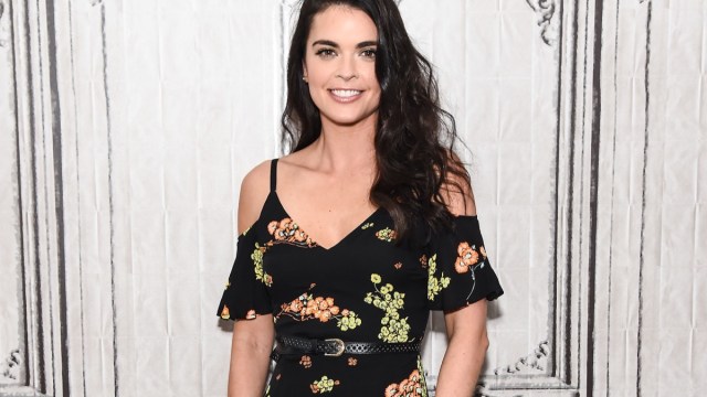 katie lee in black cold shoulder dress with floral print