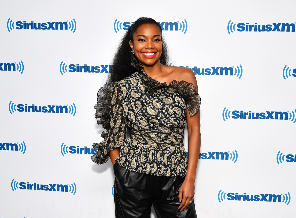 gabrielle union in black off the shoulder top and red lipstick