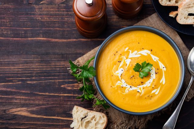 butternut squash soup in black bowl