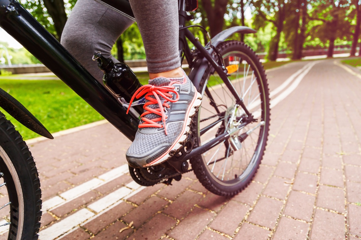 cyclist woman feet riding mountain bike on trail