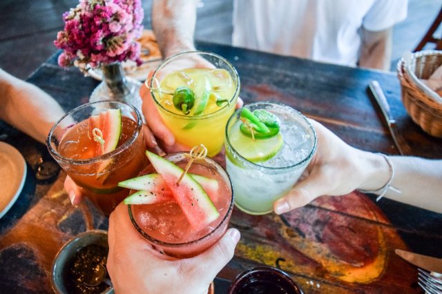 group of people toasting with margaritas or cocktails