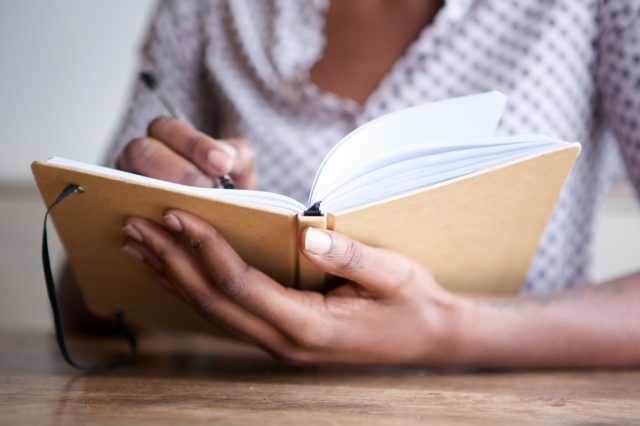 author at home writing in journal