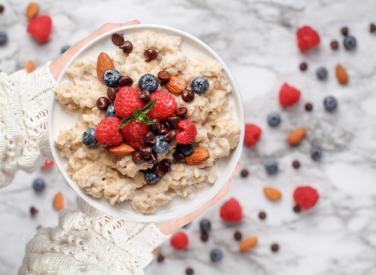 bowl of oatmeal with berries nuts and chocolate