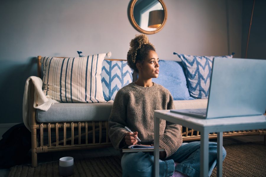 girl sitting while writing signs the universe that someone is thinking of you