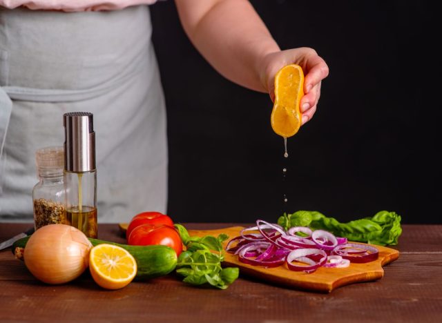 Squeezing Lemon onto Vegetables