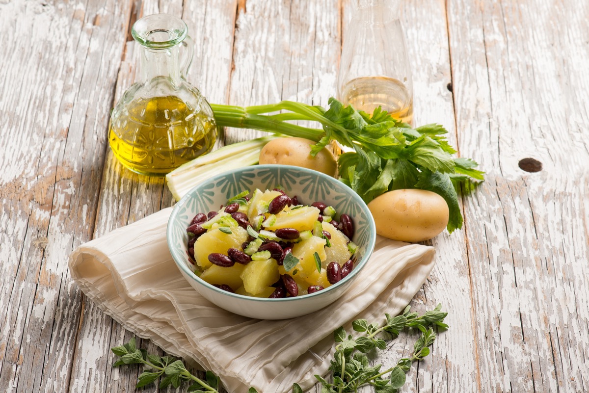 Potatoes salad with red beans oregano and celery.