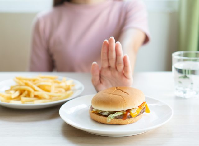 woman pushing away fast food