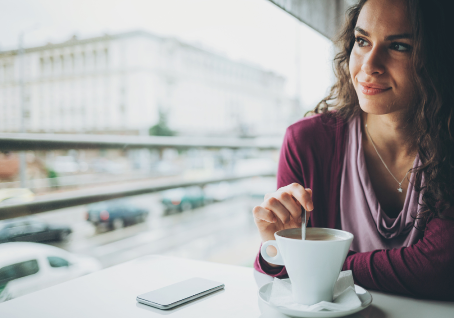 woman enjoying her coffee signs your twin flame is communicating with you